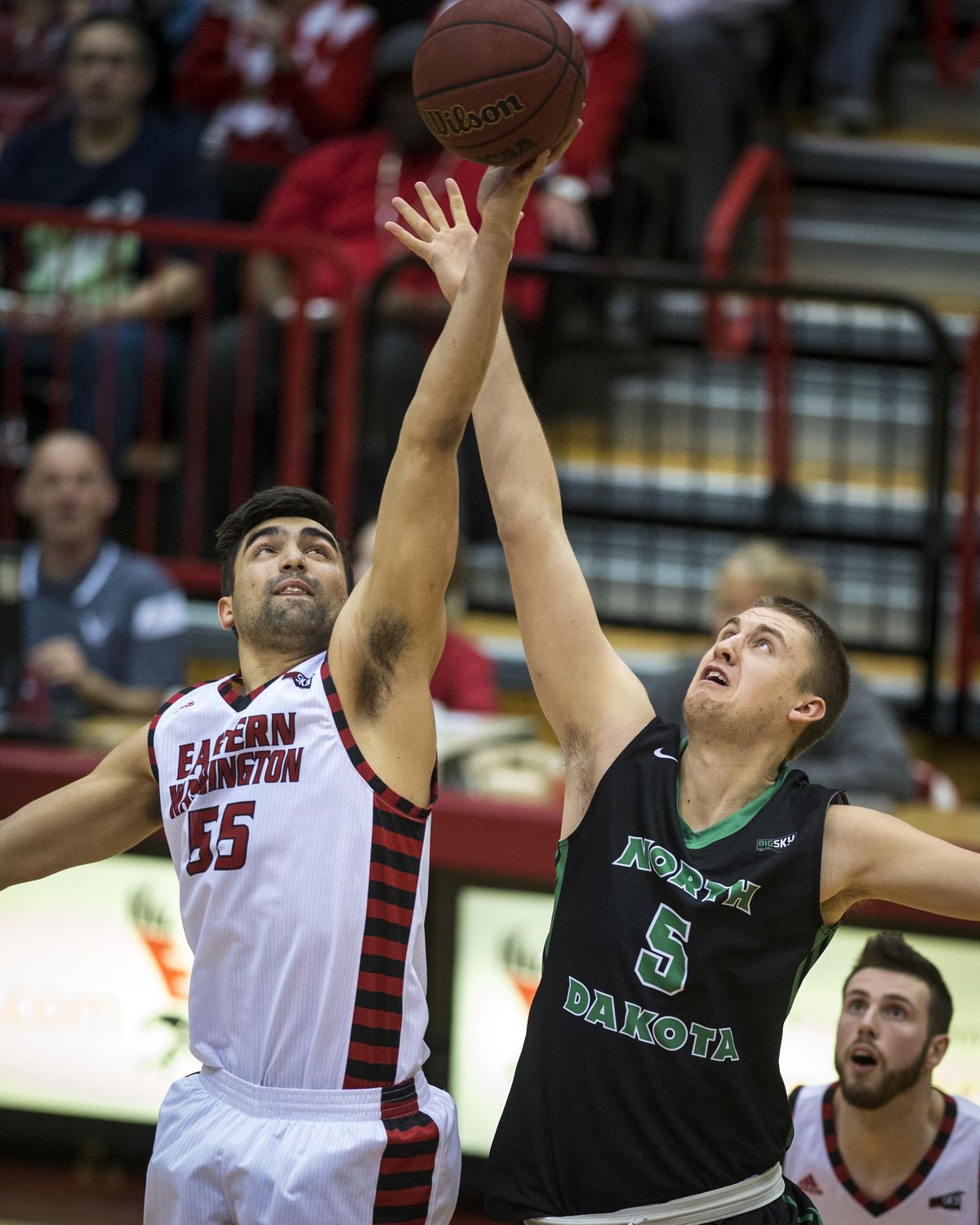 Eastern Washington forward Venky Jois, left, gets a hand on the ball first during the opening tip off against North Dakota on Feb. 11 at Reese Court. (Colin Mulvany / The Spokesman-Review)