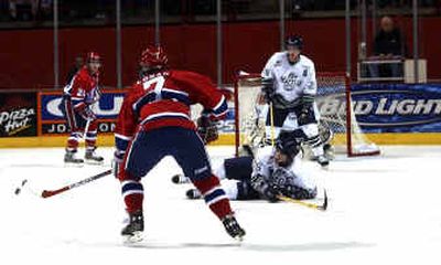 
Spokane's Joe Logan tries to avoid a sliding Seattle defender for a shot on goal during the Chiefs' 5-1 victory over the Thunderbirds Friday night at the Arena. 
 (Amanda Smith / The Spokesman-Review)