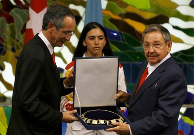 Cuban President Raul Castro, right, receives the Order of the Quetzal from Guatemala’s President Alvaro Colom in Havana on Monday. Colom is in Cuba on a three-day official visit.  (Associated Press / The Spokesman-Review)