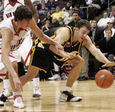 
New Mexico's Daniel Faris, left, and Wichita State's Phillip Thomasson (11) fight for a loose ball Friday night. 
 (Associated Press / The Spokesman-Review)