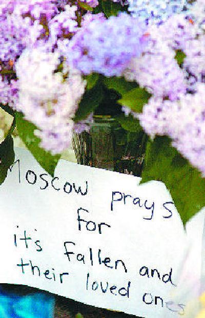 
A bouquet of lilacs sits at the base of a makeshift memorial set up in honor of slain  Moscow police Officer Lee Newbill at the intersection of Van Buren and Third streets. 
 (The Spokesman-Review)