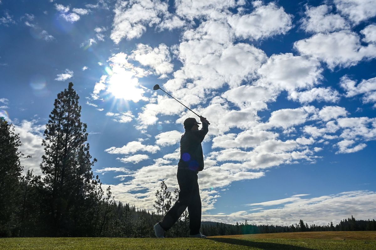 Scott Harris, 73, watches the flight of his tee shot as he was the first on course for opening day at The Creek at Qualchan Golf Course Wednesday, March, 13, 2024, in Spokane. Harris says the has played the course every year since it was built in 1992. On a day like today, "I feel 18 again," he said.  (DAN PELLE/THE SPOKESMAN-REVIEW)