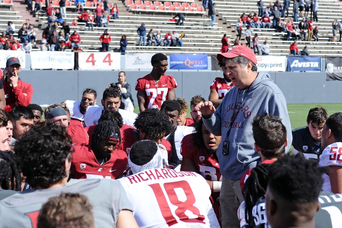 Washington State coach Mike Leach talks with his players after the Crimson and Gray football game on Saturday, April 21, 2018 at Joe Albi Stadium. (James Snook / Special for The Spokesman-Review)