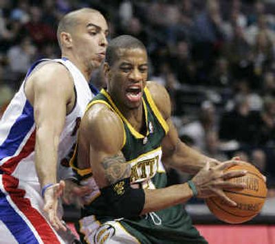 
Seattle's Antonio Daniels, right, drives to the basket against Detroit's Carlos Arroyo in the first half on Wednesday. 
 (Associated Press / The Spokesman-Review)