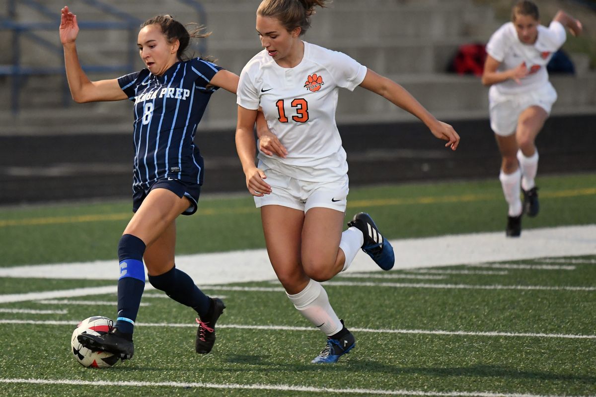 Gonzaga Prep's Chelsea Le moves the ball downfield as visiting Lewis and Clark's Ella Damon (13) defends on Sept. 25, 2019.  (COLIN MULVANY)