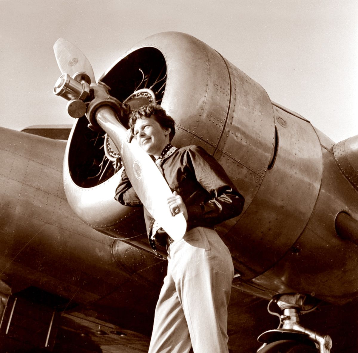 Amelia Earhart poses with her plane in a photo taken by Albert Bresnik at Burbank Airport in Burbank, Calif., on May 20, 1937. (Associated Press)