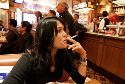 
A student smokes a cigarette in a cafe in Paris on Tuesday. A French parliamentary panel called Tuesday for the government to ban smoking in public places such as cafes and restaurants. 
 (Associated Press / The Spokesman-Review)