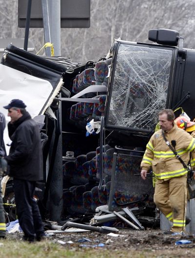 FILE - This March 12, 2011 file photo shows emergency personnel investigating the scene of a bus crash on Interstate-95 in the Bronx borough of New York. The driver of the tour bus that crashed while returning from a quick overnight trip to a casino, killing 15, has been indicted on manslaughter charges, a law enforcement official said Thursday, Sept. 1, 2011. (David Karp / Fr50733 Ap)