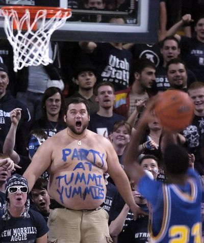 ORG XMIT: UTLHJ105 Utah State fan Bill Sproat, (without shirt on) tries to to distract San Jose State guard Robert Owens as he shoots a free throw during during an NCAA college basketball game Saturday, March 7, 2009, in Logan, Utah. (AP Photo/The Herald Journal, Eli Lucero) (Eli Lucero / The Spokesman-Review)
