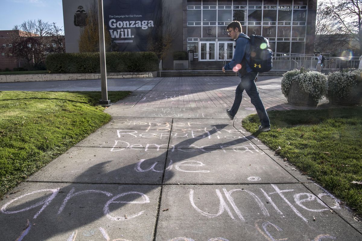 Chalk messages of unity cover the sidewalks near the Crosby Center on the Gonzaga University campus, Friday, Nov. 11, 2016, in Spokane, Wash. (Dan Pelle / The Spokesman-Review)