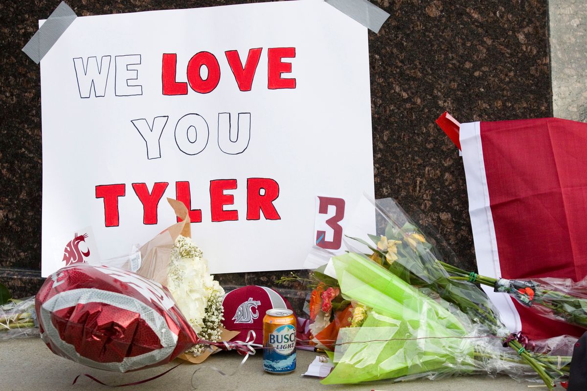 Items are left at a makeshift memorial for Washington State quarterback Tyler Hilinski outside Martin Stadium in Pullman, Wash., Wednesday, Jan. 17, 2018. Police are interviewing Hilinski's friends and people who knew him to try to learn why he apparently took his life. The 21-year-old Hilinski was found in his Pullman apartment on Tuesday after he didn't show up for practice, dead from an apparent self-inflicted gunshot wound. Police also found a rifle and a suicide note. (Geoff Crimmins/The Moscow-Pullman Daily News via AP) ORG XMIT: IDMOS302  (Geoff Crimmins)