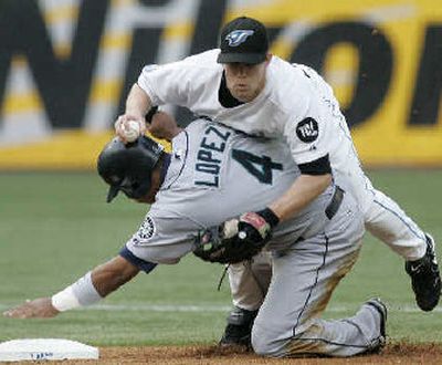 
Seattle's Jose Lopez collides with Toronto shortstop Aaron Hill.
 (Associated Press / The Spokesman-Review)