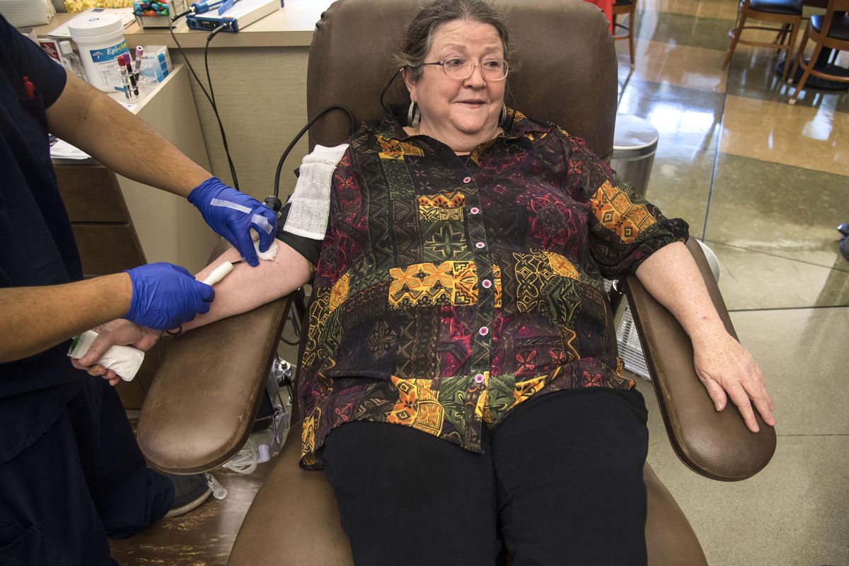 Mary Ann Carey donates  blood at the Inland Northwest Blood Center on Wednesday, Aug. 31, 2017, in Spokane, Wash. (Dan Pelle / The Spokesman-Review)