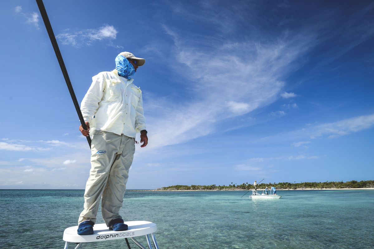 Avalon guide Leonardo Martinez Arche poles a skiff in search of bonefish off the Cuba mainland with Spokane fly fisher Sean Visintainer of Silver Bow Fly Shop.