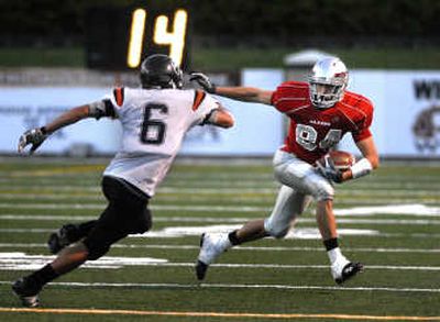 
Ferris receiver Jared Karstetter, right, attempts to juke Lewis and Clark defensive back Vaughn Kapiko during Thursday's game. 
 (Jed Conklin / The Spokesman-Review)
