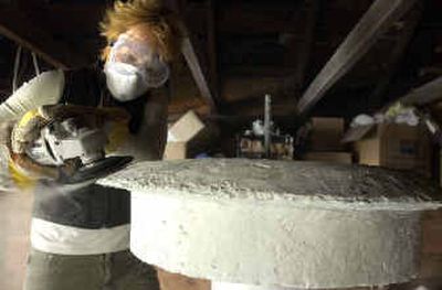 
Artist Rachel Dolezal sands part of the sculpture-fountain she is building for the 