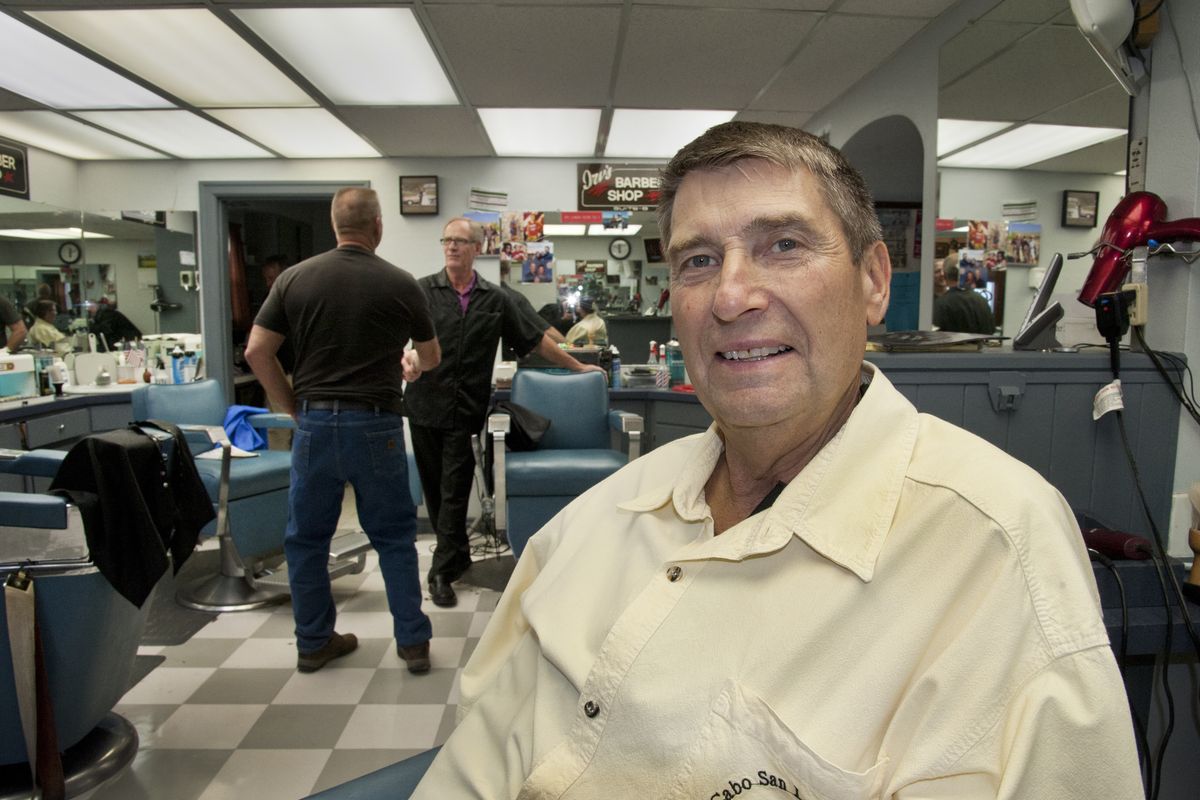 Tom Groh turned Tom’s Barber Shop into a Spokane Valley icon. Longtime customer Steve Hatcher, background left, chats with Irv Groh after receiving a haircut on April 8. (Dan Pelle)