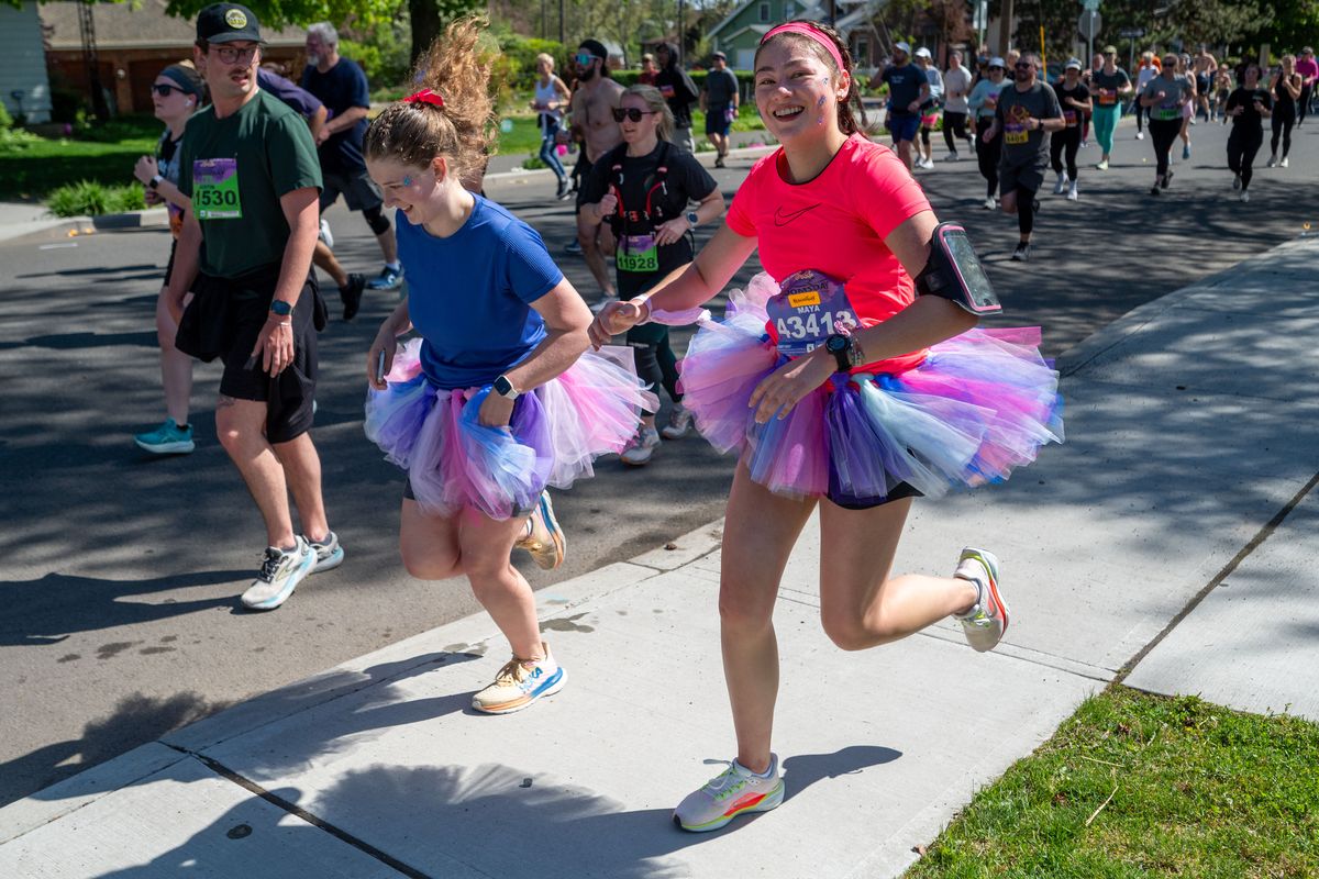 Runners dressed in tutus head into West Central after summiting Doomsday Hill during the running the 49th Bloomsday on May 4 in Spokane. 