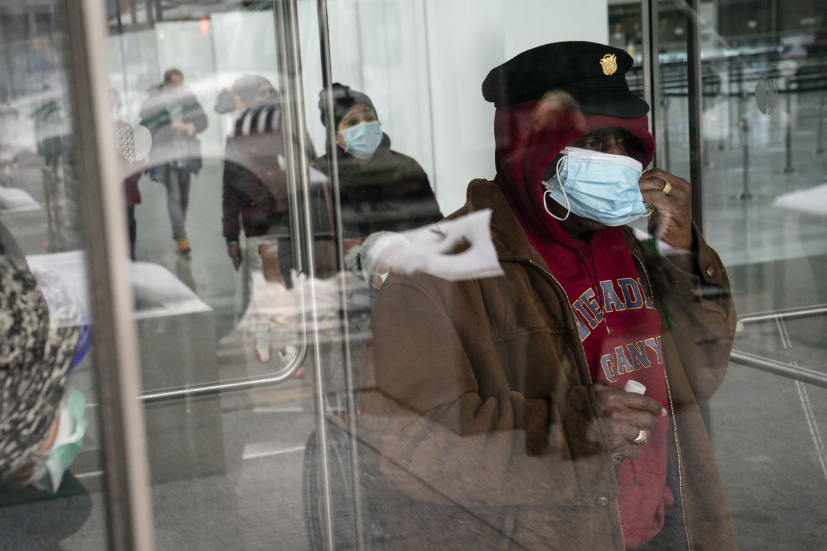 FILE - In this Feb. 3, 2021, file photo, a patient adjusts his face mask as he leaves a COVID-19 vaccination site inside the Jacob K. Javits Convention Center in New York. States are beginning to ease coronavirus restrictions, but health experts say we don’t know enough yet about variants to roll back measures that could help slow their spread. (John Minchillo)