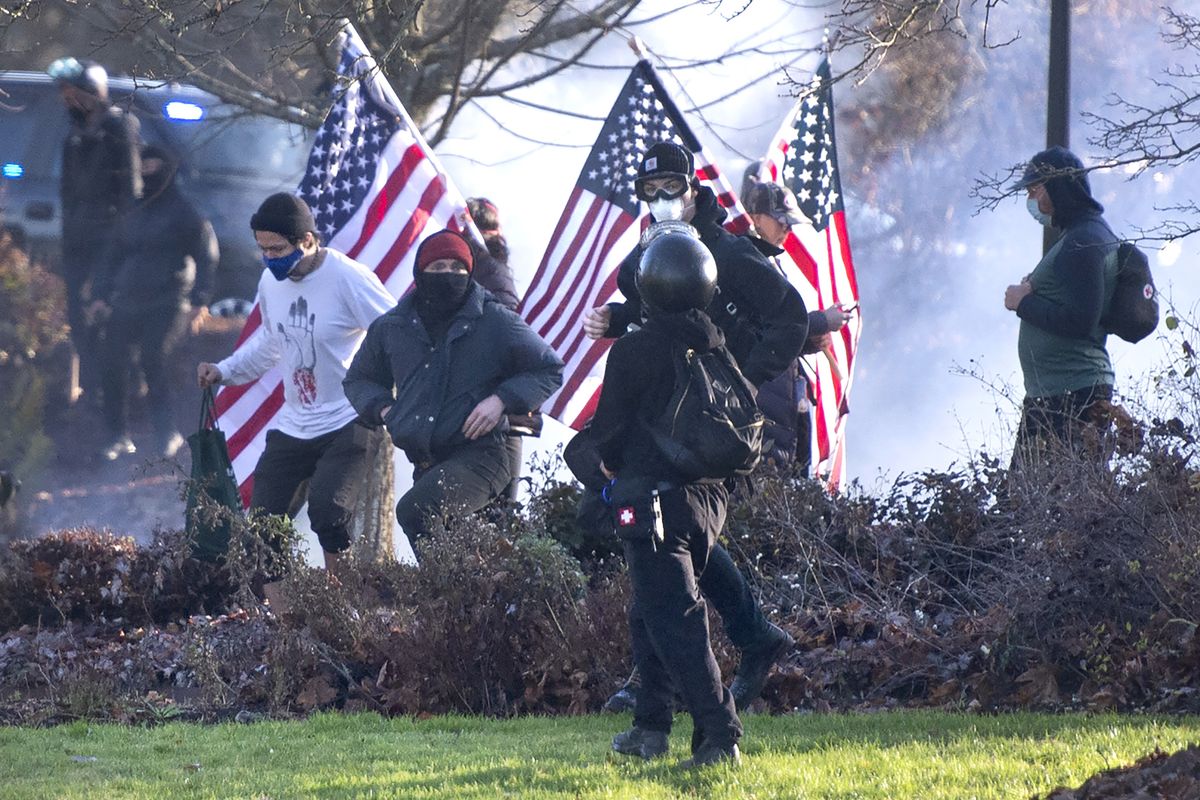 Supporters of President Donald Trump and antifa supporters clashed with Washington state police on Dec. 12 on the state Capitol Campus in Olympia. Police in Olympia declared a riot and arrested at least one person as groups with different points of view held simultaneous protests.  (MBO)