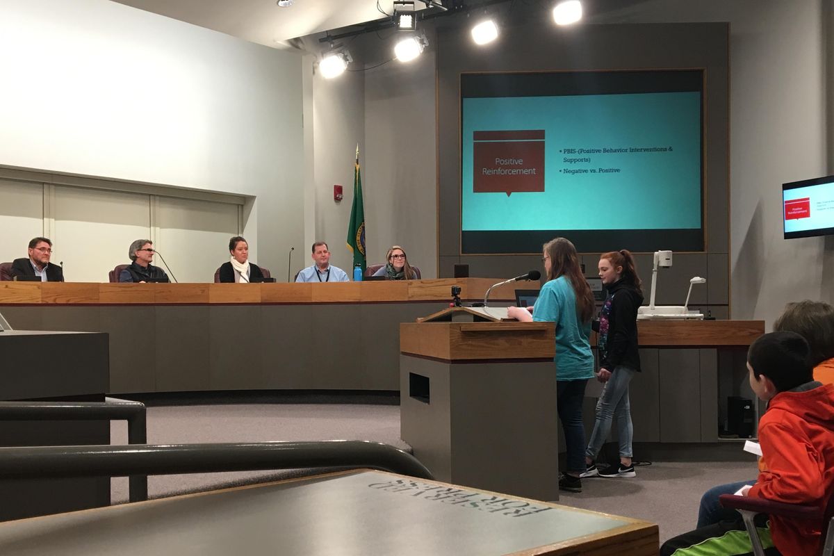 Regal Elementary School students Cheyenne Richey, left, and Erica Stilson, right, present a proposal on school zone cameras to Spokane City councilmembers and other city officials at City Hall on Thursday, Feb. 15, 2018. Richey and Stilson are members of Aron Watts’ sixth grade class, who were finishing up a class project aimed at promoting safety for students near schools. (Kip Hill / The Spokesman-Review)