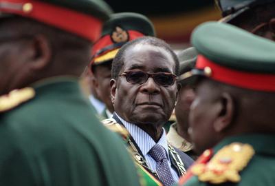 Zimbabwean President Robert Mugabe inspects a guard of honor during Armed Forces Day celebrations Tuesday.  (Associated Press / The Spokesman-Review)