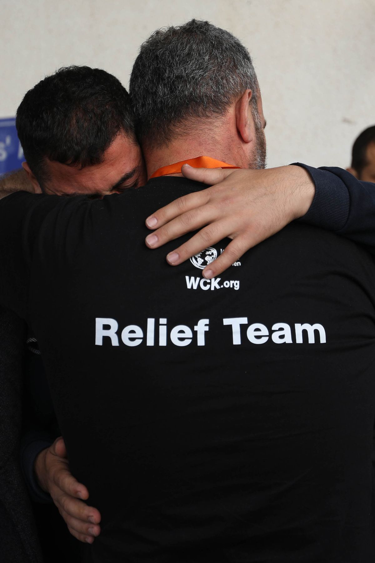 Two men become emotional and comfort each other as they receive the bodies of World Central Kitchen workers who were killed by Israeli air strikes on April 2, 2024, in Rafah, Gaza. In a statement, the charity World Central Kitchen said that seven of its workers were killed while driving in a convoy after leaving a warehouse in Deir al-Balah, in central Gaza, where they had unloaded humanitarian food aid brought there via ship.    (Ahmad Hasaballah/Getty Images Europe/TNS)