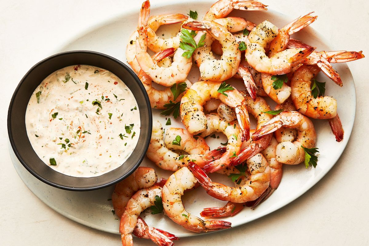 Roasted shrimp cocktail with horseradish sauce in New York, May 9, 2023. Do as Melissa Clark does, and roast, don’t poach, the shrimp, then serve them with a creamy horseradish rémoulade. (ARMANDO RAFAEL/New York Times)