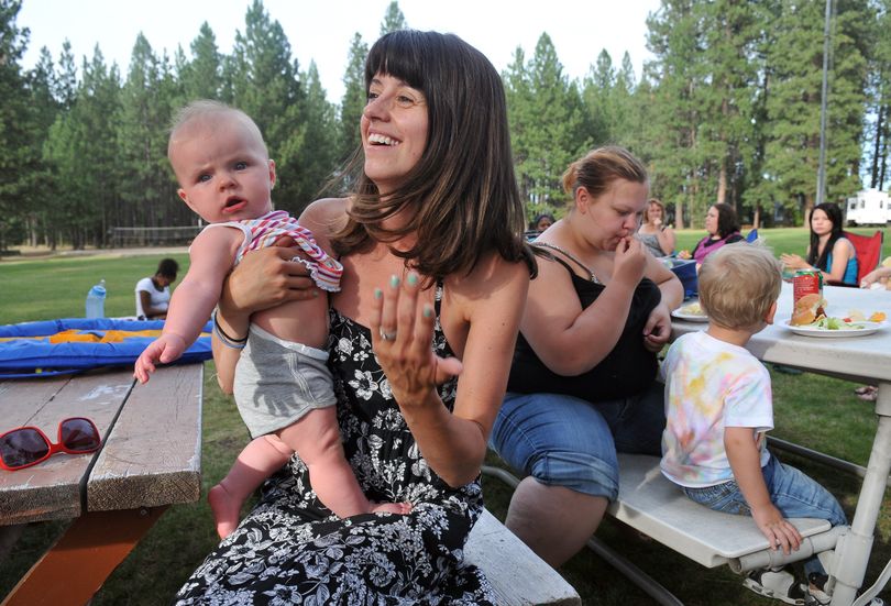 Shauna Edwards holds 7-month-old Landry Kopp during a meeting of Young Lives on Aug. 5 at Camp White in Post Falls. (Jesse Tinsley)