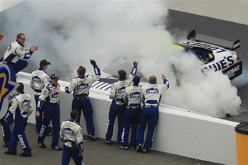 Jimmie Johnson does a burnout for his No. 48 Lowe's Chevrolet pit crew after earning his 50th career NASCAR Sprint Cup Series win. (Photo courtesy of Chris McGrath/Getty Images)
