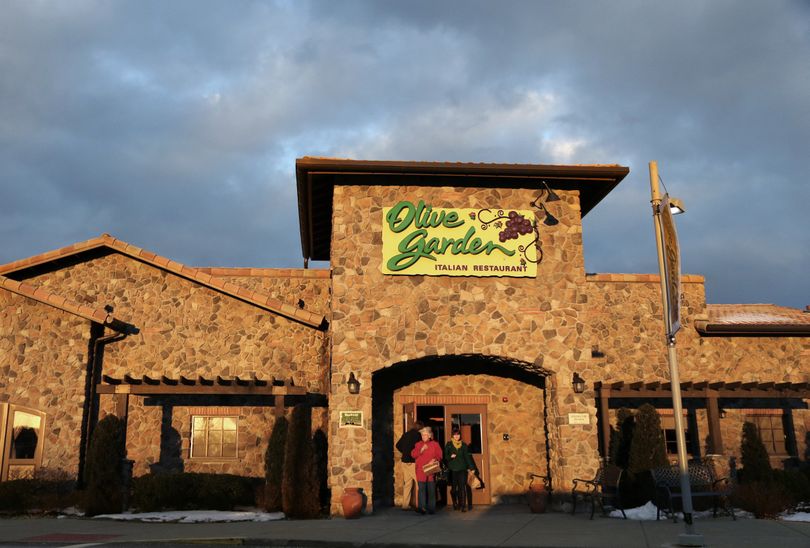 People leave an Olive Garden restaurant at sunset in Foxborough, Mass., on March 20. (Associated Press)