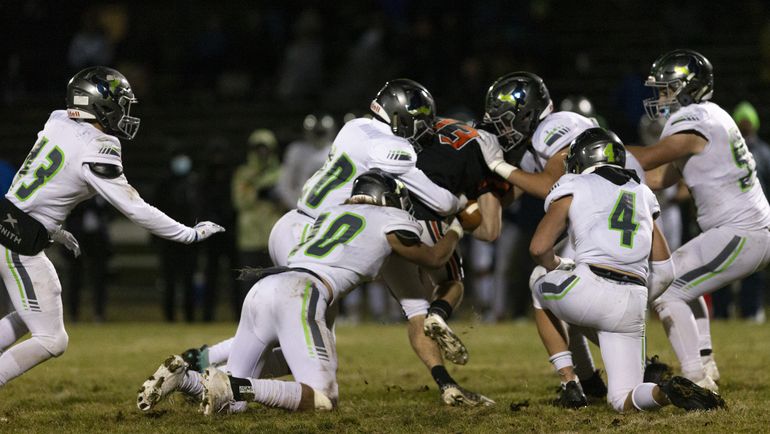 Post Falls senior Tommy Hauser, who had 18 catches for 182 yards, is tackled by a swarm of Mountain View defenders during Friday’s 5A State game in Post Falls. (Cheryl Nichols/For The Spokesman-Review)