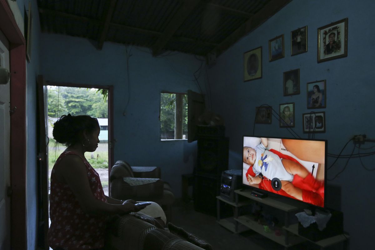 Adalicia Montecinos watches a video July 18, 2018, at her home in La Libertad, Honduras, of her son Johan Bueso Castillo who was separated from his father at the Texas border. Montecinos watches videos of her infant son Johan over and over again. She had recorded each month of his life before he left for the United States with his father. (Esteban Felix / AP)