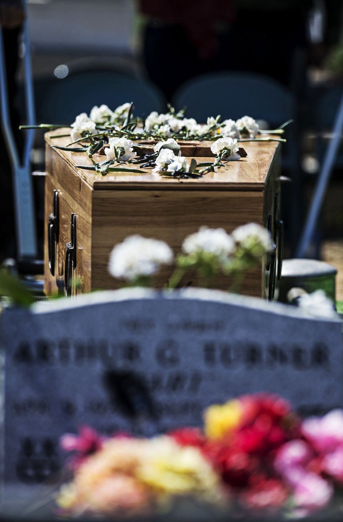 Flowers rest on Bob Wood’s casket before his burial next to longtime friend Art Turner.