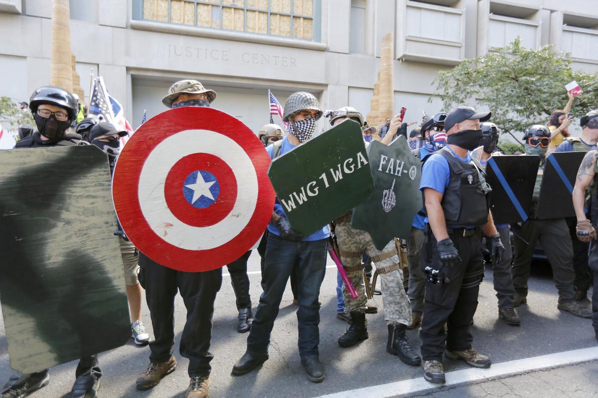 Opposing rallies battle with mace, paint balls and rocks near Justice Center in downtown Portland Saturday, August 22, 2020. Dueling demonstrations in Portland by right-wing and left-wing protesters have turned violent near a county building that