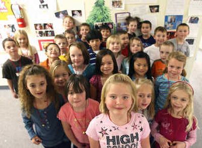 
Kynli Mahnke, front center, stands with first-grade classmates at Xavier Charter School on Wednesday in Twin Falls, Idaho. The 7-year-old decided to raise money for a headstone at the grave site of a 2-year-old boy slain  by the woman watching him. Associated Press
 (Associated Press / The Spokesman-Review)