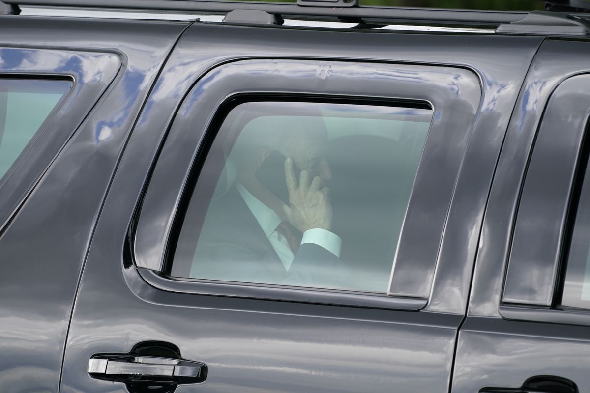 President Joe Biden speaks on his phone after he and first lady Jill Biden arrived on the Ellipse near the White House, Friday, June 4, 2021, in Washington. Biden returns to the White House after spending a few days in Rehoboth Beach to celebrate first lady Jill Biden