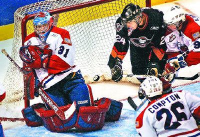 
Spokane's David Linsley, far right, battles Calgary's Derek LeBlanc as the puck sails wide of Chiefs goalie Kevin Armstrong. 
 (Brian Plonka / The Spokesman-Review)