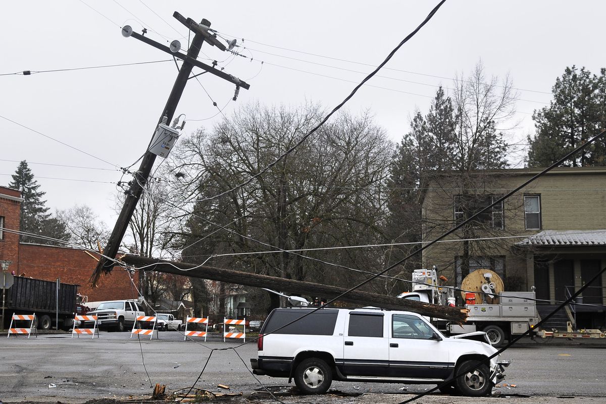 A two-car crash resulted in the snapping of a power pole at the corner of Ninth Avenue and Monroe Street on Tuesday, Jan. 25, 2011. (Dan Pelle / The Spokesman-Review)