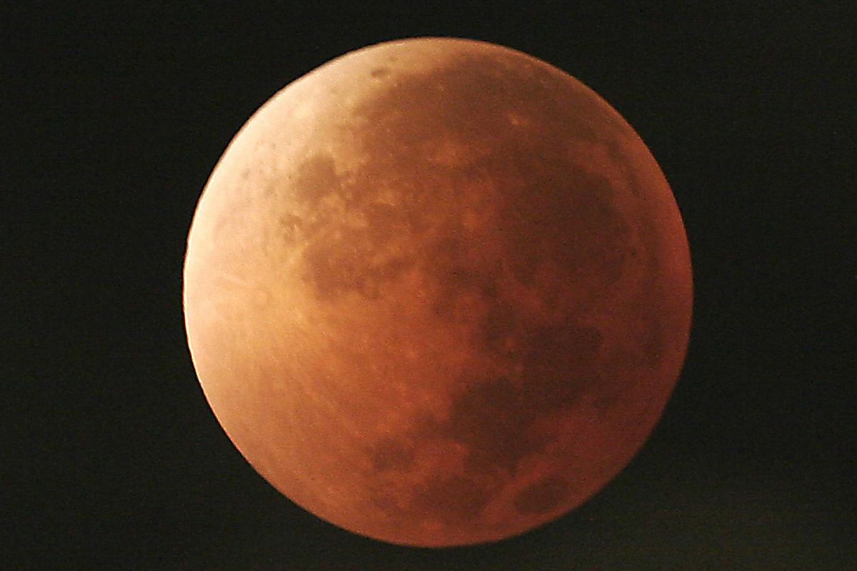In this Aug. 28, 2007, file photo, the moon takes on different orange tones during a lunar eclipse seen from Mexico City. (Marco Ugarte / Associated Press)