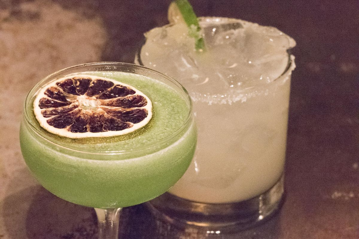 Beyond is the classic margarita and in the foreground is Ben Poffenroth’s  variation, which includes a generous scoop of pepper jelly and a garnish of dehydrated lime. Poffenroth is an owner at Durkin’s Liquor Bar in Spokane. On Sept. 21, 2019, the Friends of Manito will offer a class on how to dehydrate foods at the South Hill Library. (Jesse Tinsley / The Spokesman-Review)