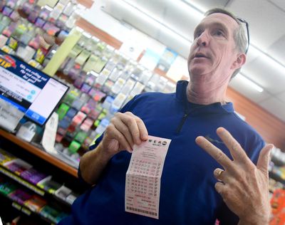 Rick Dowd, a New Hampshire resident, talks about buying his Powerball tickets in New York, Massachusetts and New Hampshire Sunday at J&J Discount Mini Mart in South Boston.  (TRIBUNE NEWS SERVICE)