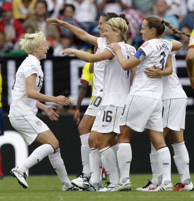 Megan Rapinoe, left, is greeted by teammates after scoring the second goal for the U.S. (Associated Press)