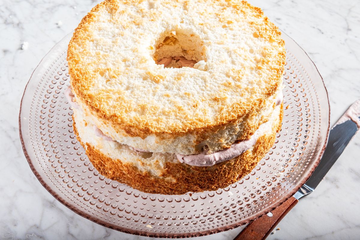 Angel food cake that’s been split and filled, but not frosted (yet). Food styling by Lisa Cherkasky for the Washington Post.  (Rey Lopez/For The Washington Pos)