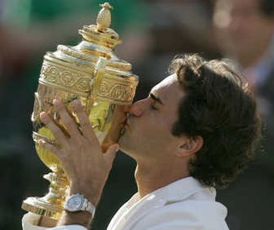 
Switzerland's Roger Federer kisses the trophy after defeating Spain's Rafael Nadal to earn his 11th Grand Slam title.Associated Press
 (Associated Press / The Spokesman-Review)