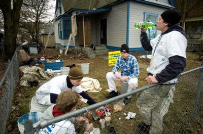 
College Pro Painting trainees take a lunch break last week on West Boone Avenue in Spokane's West Central neighborhood.  College Pro is painting 10 low-income families' homes for free. 
 (Photos by Colin Mulvany / The Spokesman-Review)