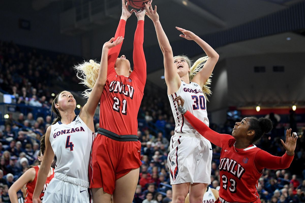 UNLV Rebels forward/center Katie Powell (21) grabs a rebound against Gonzaga Bulldogs guard Chandler Smith (30) during the first half of a college basketball game on Saturday, Dec 9, 2017, at McCarthey Athletic Center in Spokane, Wash. (Tyler Tjomsland / The Spokesman-Review)
