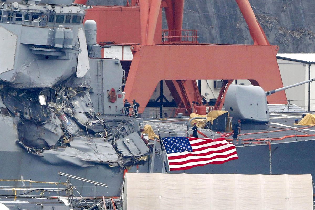 Damaged USS Fitzgerald is seen at Yokosuka Naval Base, south of Tokyo, Sunday, June 18, 2017. Navy divers found the bodies of missing sailors Sunday aboard the stricken USS Fitzgerald that collided with a container ship Saturday in the busy sea off Japan, the Navy said. (Associated Press)
