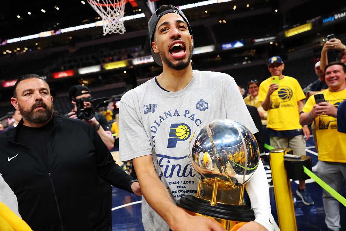 Tyrese Haliburton (0) of the Indiana Pacers celebrates with the Bob Cousy Trophy after the 125-108 win against the New York Knicks in Game 6 of the Eastern Conference Finals of the 2025 NBA Playoffs at Gainbridge Fieldhouse on Saturday, May 31, 2025, in Indianapolis. (Tribune News Service)