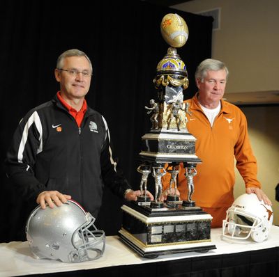 Ohio State’s Jim Tressel, left, and Texas’ Mack Brown both hope to hoist this trophy tonight. (Associated Press / The Spokesman-Review)